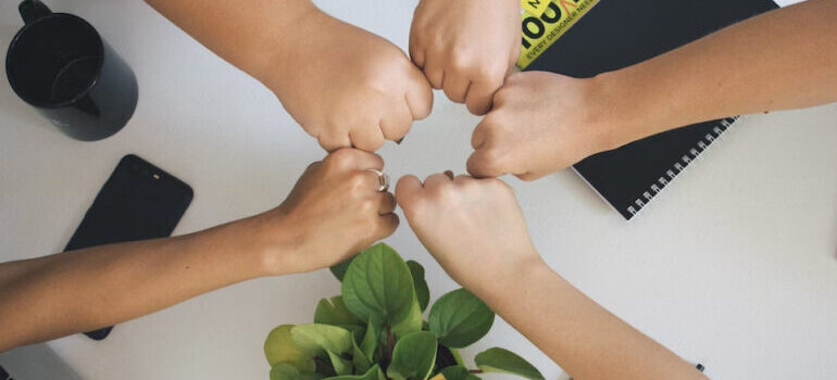 5 people gathering hands
