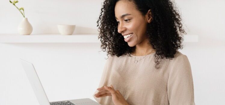 A woman checking different types of office layouts on her laptop
