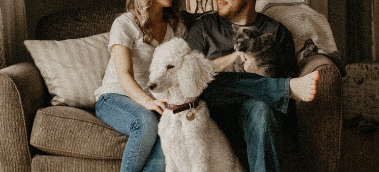 a couple with a white dog 