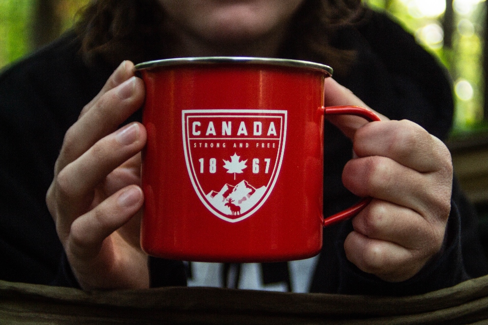 A person holding a cup that says Canada