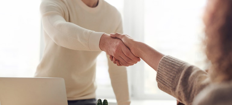 man shaking a woman's hand after a job interview