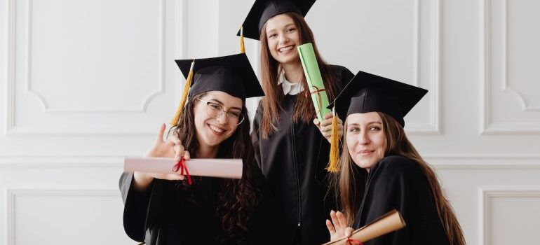 three young women graduating